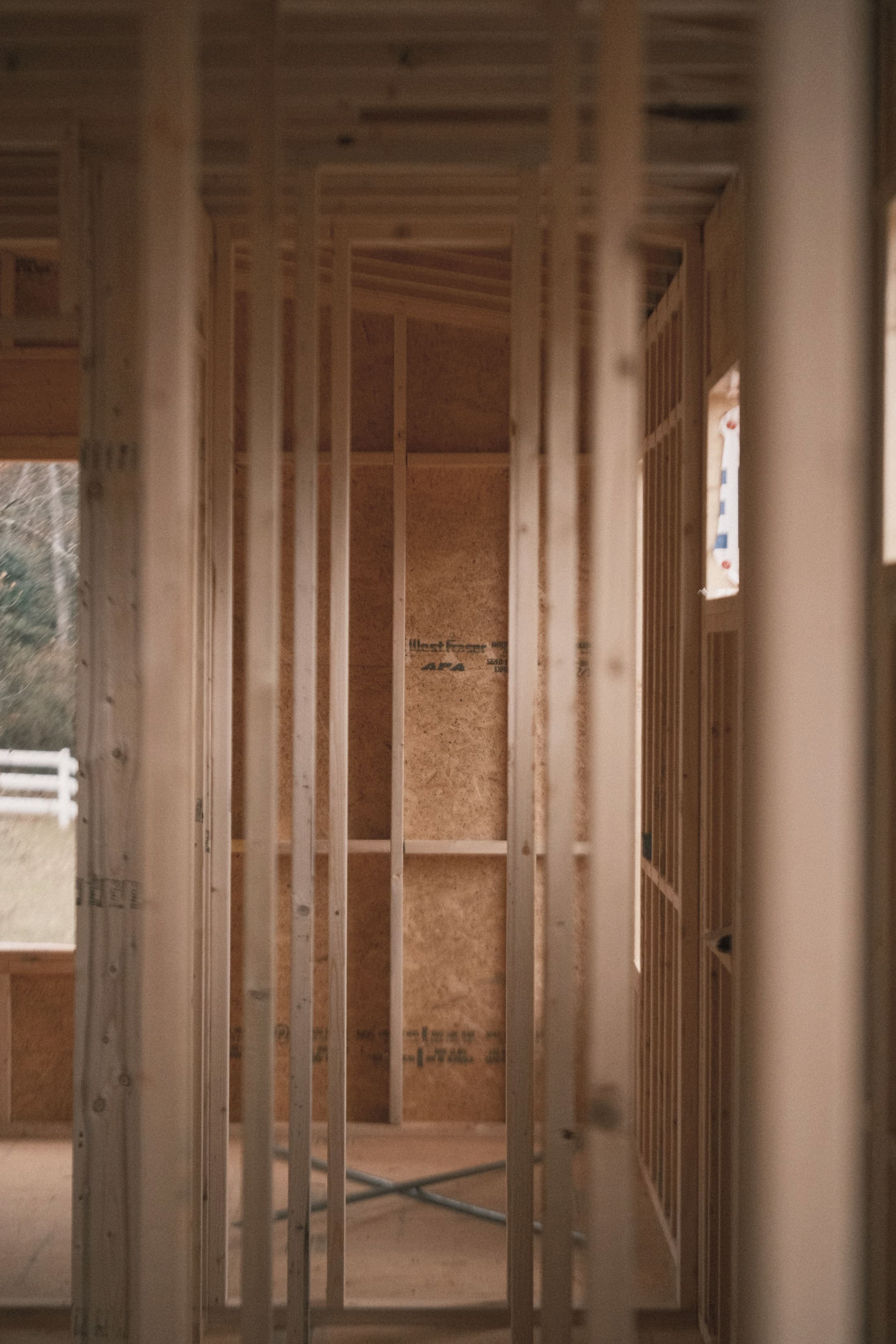 Interior wall framing of a house under construction, in soft light